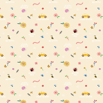 Patterned cotton fabric with punch buggy / love bug cars, flowers, lady bugs and text saying enjoy the ride on a beige / natural background