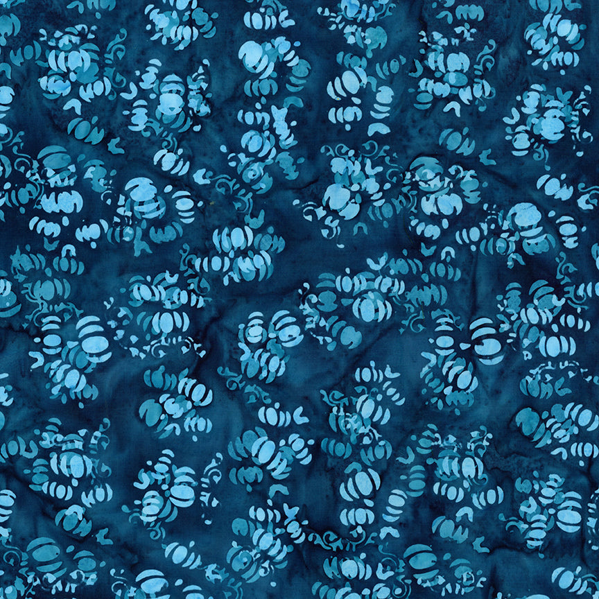 Fabric pattern Bluejay: hand dyed deep blue with scattered pumpkin shapes from The Whispering Hollows collection which features fun Halloween images, with colors invoking midnight skies, as well as favorite seasonal hues. The Batiks Collections by Riley Blake are produced in state-of-the-art facilities with the best Tjap designers and makers, color experts, and stamp prodigies.