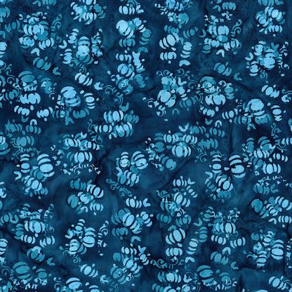 Fabric pattern Bluejay: hand dyed deep blue with scattered pumpkin shapes from The Whispering Hollows collection which features fun Halloween images, with colors invoking midnight skies, as well as favorite seasonal hues. The Batiks Collections by Riley Blake are produced in state-of-the-art facilities with the best Tjap designers and makers, color experts, and stamp prodigies.