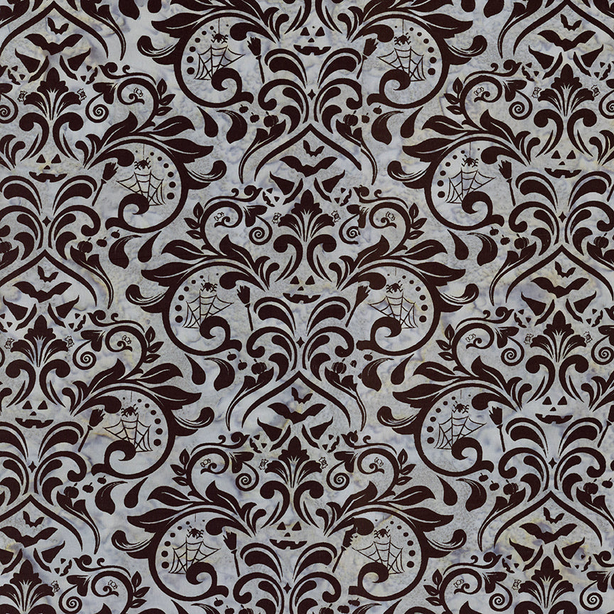 Fabric pattern Embrace the Grey:  a gothic damask pattern dyed on grey background from The Whispering Hollows collection which features fun Halloween images, with colors invoking midnight skies, as well as favorite seasonal hues. The Batiks Collections by Riley Blake are produced in state-of-the-art facilities with the best Tjap designers and makers, color experts, and stamp prodigies.