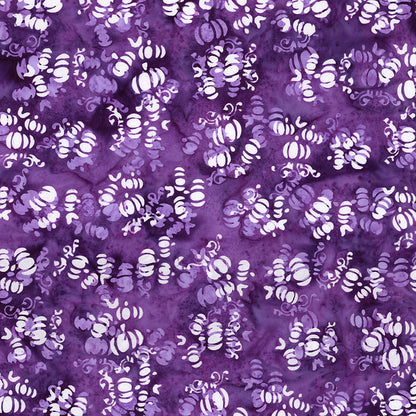 Fabric pattern Grape Soda: hand dyed deep purple fabrics with scattered pumpkin shapes from The Whispering Hollows collection which features fun Halloween images, with colors invoking midnight skies, as well as favorite seasonal hues. The Batiks Collections by Riley Blake are produced in state-of-the-art facilities with the best Tjap designers and makers, color experts, and stamp prodigies.