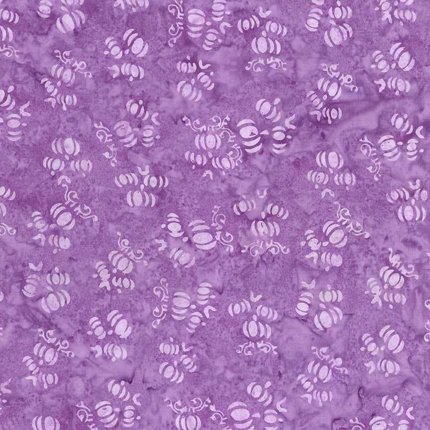 Fabric pattern Purple outburst: hand dyed purple fabric with scattered pumpkin shapes from The Whispering Hollows collection which features fun Halloween images, with colors invoking midnight skies, as well as favorite seasonal hues. The Batiks Collections by Riley Blake are produced in state-of-the-art facilities with the best Tjap designers and makers, color experts, and stamp prodigies.