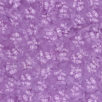 Fabric pattern Purple outburst: hand dyed purple fabric with scattered pumpkin shapes from The Whispering Hollows collection which features fun Halloween images, with colors invoking midnight skies, as well as favorite seasonal hues. The Batiks Collections by Riley Blake are produced in state-of-the-art facilities with the best Tjap designers and makers, color experts, and stamp prodigies.