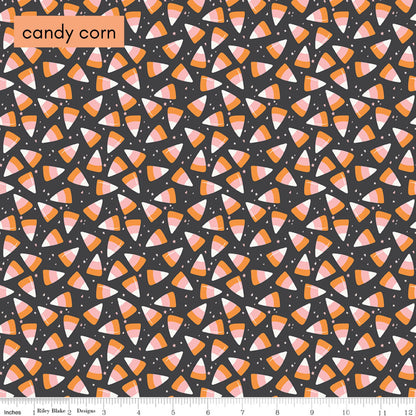 Pattern of candy corn on a black background with a ruler at the bottom.