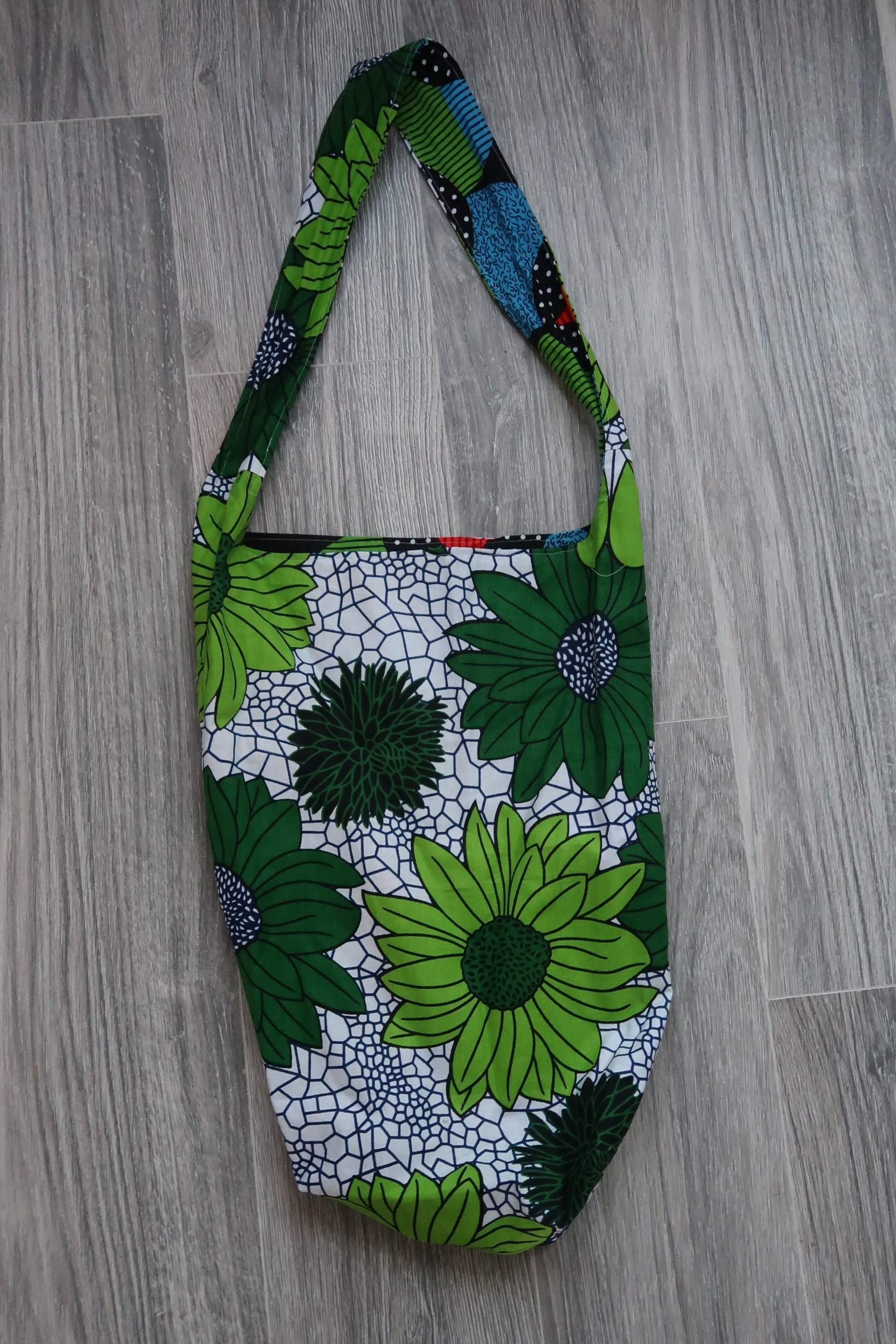 Yoga mat bag cotton fabric white background with large bright Floral pattern, interior lining black with colorful large circles. 