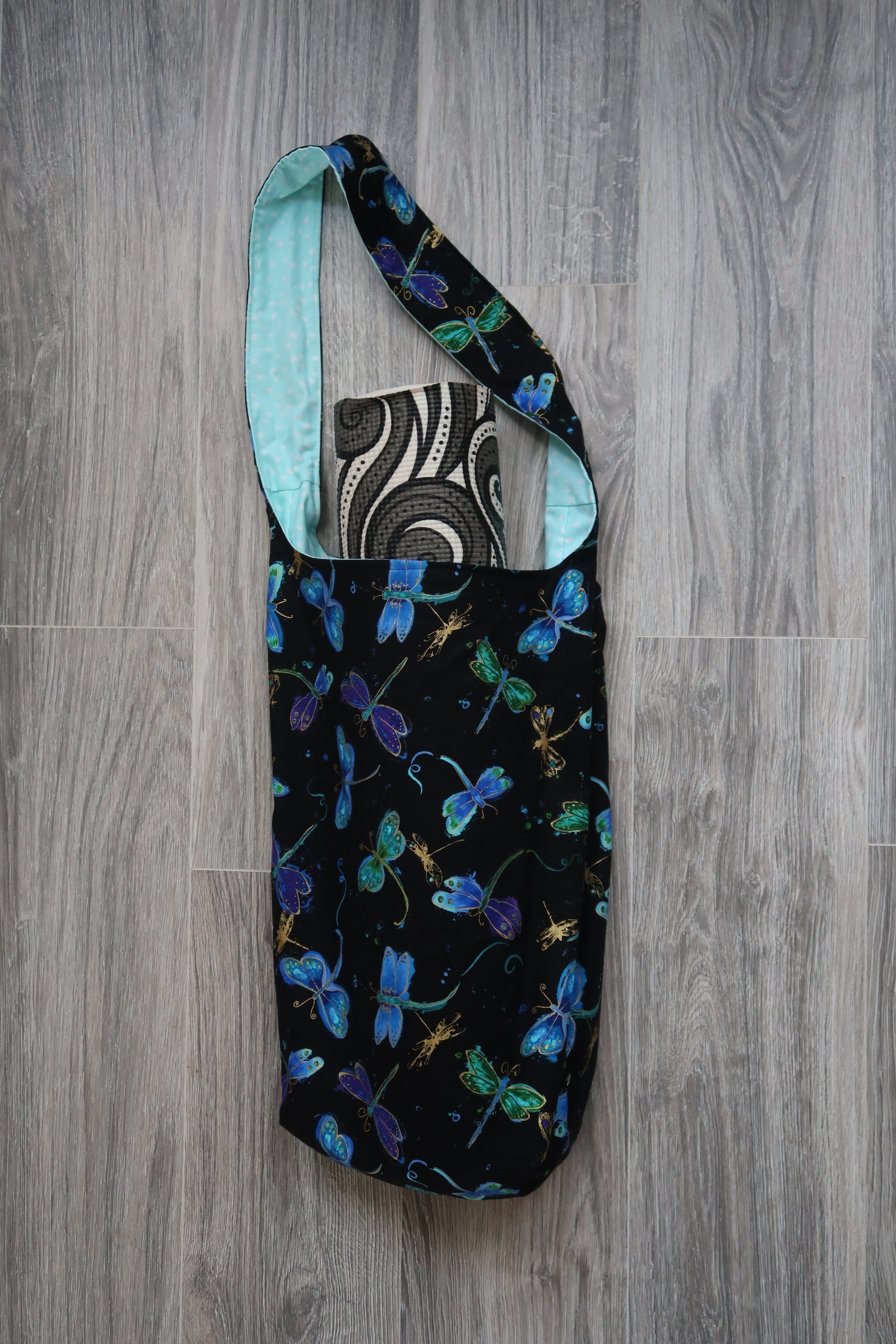 yoga mat bag Black fabric with colorful dragonfly pattern , interior lining is light floral pattern