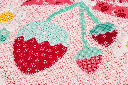 The Strawberry Crush Sew Along Quilt Kit includes the Strawberry Crush Sew Simple Shapes™ and fabric for quilt top and binding. Backing not included. Fabric featured is Berry & Sage by Lori Holt of Bee in my Bonnet. Pattern is also by Lori Holt. Finished size is 66 1/2" x 73 1/2". 
Kit comes in a strawberry-shaped box. Box size is approximately 13 1/2" x 11 3/4" x 3 1/4". 

The Sew Along Guide is included in the  kit but you can also go to Lori Holt's blog A Bee in my Bonnet.