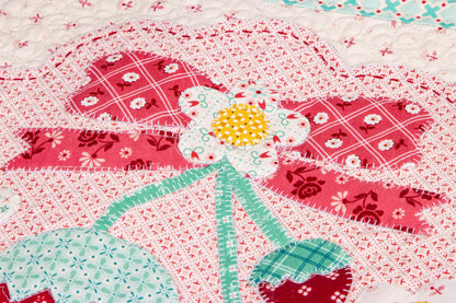 The Strawberry Crush Sew Along Quilt Kit includes the Strawberry Crush Sew Simple Shapes™ and fabric for quilt top and binding. Backing not included. Fabric featured is Berry & Sage by Lori Holt of Bee in my Bonnet. Pattern is also by Lori Holt. Finished size is 66 1/2" x 73 1/2". 
Kit comes in a strawberry-shaped box. Box size is approximately 13 1/2" x 11 3/4" x 3 1/4". 

The Sew Along Guide is included in the  kit but you can also go to Lori Holt's blog A Bee in my Bonnet.
