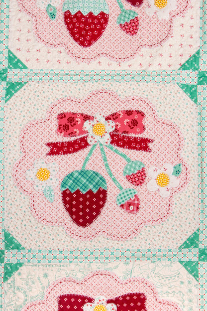 The Strawberry Crush Sew Along Quilt Kit includes the Strawberry Crush Sew Simple Shapes™ and fabric for quilt top and binding. Backing not included. Fabric featured is Berry & Sage by Lori Holt of Bee in my Bonnet. Pattern is also by Lori Holt. Finished size is 66 1/2" x 73 1/2". 
Kit comes in a strawberry-shaped box. Box size is approximately 13 1/2" x 11 3/4" x 3 1/4". 

The Sew Along Guide is included in the  kit but you can also go to Lori Holt's blog A Bee in my Bonnet.