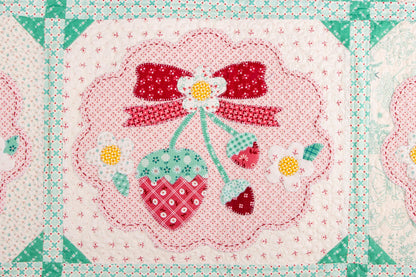 The Strawberry Crush Sew Along Quilt Kit includes the Strawberry Crush Sew Simple Shapes™ and fabric for quilt top and binding. Backing not included. Fabric featured is Berry & Sage by Lori Holt of Bee in my Bonnet. Pattern is also by Lori Holt. Finished size is 66 1/2" x 73 1/2". 
Kit comes in a strawberry-shaped box. Box size is approximately 13 1/2" x 11 3/4" x 3 1/4". 

The Sew Along Guide is included in the  kit but you can also go to Lori Holt's blog A Bee in my Bonnet.