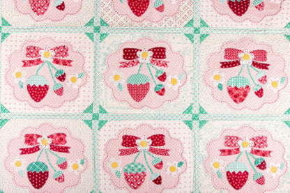 The Strawberry Crush Sew Along Quilt Kit includes the Strawberry Crush Sew Simple Shapes™ and fabric for quilt top and binding. Backing not included. Fabric featured is Berry & Sage by Lori Holt of Bee in my Bonnet. Pattern is also by Lori Holt. Finished size is 66 1/2" x 73 1/2". 
Kit comes in a strawberry-shaped box. Box size is approximately 13 1/2" x 11 3/4" x 3 1/4". 

The Sew Along Guide is included in the  kit but you can also go to Lori Holt's blog A Bee in my Bonnet.