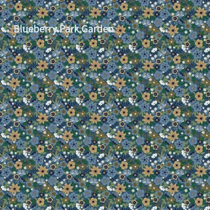 cotton fabric collection spoonful of sugar this one is a repeating pattern of small flowers in shades of blue, gold, white, and green called "Blueberry Park Garden" The floral design is dense and covers the entire surface.