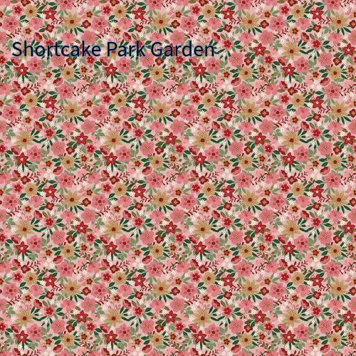 cotton fabric collection spoonful of sugar this one is a repeating pattern of small flowers in shades of blue, gold, white, and green on a pink background called "Shortcake Park Garden" The floral design is dense and covers the entire surface.