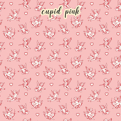 The Letters to Cupid fabric collection, the cupid  pink pattern features a white and red cupid with his bow surrounded by hearts on a pink colored background. This 100% cotton quilting fabric is 43"/44" wide and is suitable for quilting, apparel, and home decor.