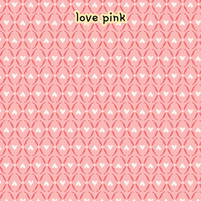 fabric collection Love Bugs 100% organic cotton fabric with a pink pattern with white hearts and oval shapes. The design is repeated across the image. Quilting, crafts, home decor, apparel sewing
