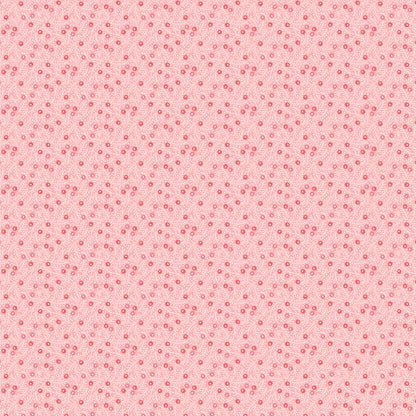In the Frost & Flurry fabric collection by Sheri McCulley (for Poppie Cotton), the “Frosted Berries” prints are designed to capture a soft, wintry version of classic holiday berry motifs. The design features small, scattered berries attached to delicate branches, arranged in an allover, tossed layout rather than formal repeats. Background is pink