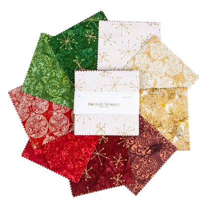 This holiday collection features unique, handcrafted batik prints ethically sourced and hand-dyed by master artisans in Indonesia. The Festive colorway highlights rich Christmas reds, deep greens, and warm accent tones embedded with shimmering metallic highlights. The designs feature swirling holiday baubles, starbursts, and intricate geometric/organic line work (such as the metallic circuit and star patterns) that catch the light, adding a sophisticated glimmer to seasonal quilts, tree skirts, table runner
