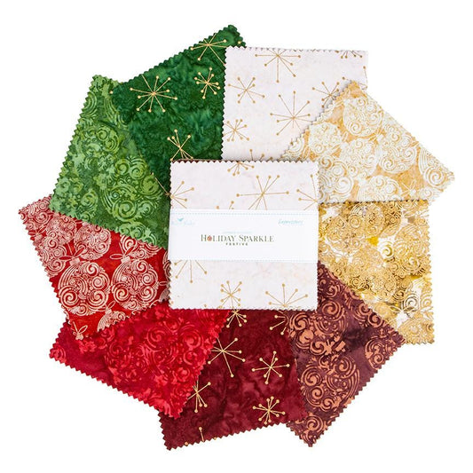 This holiday collection features unique, handcrafted batik prints ethically sourced and hand-dyed by master artisans in Indonesia. The Festive colorway highlights rich Christmas reds, deep greens, and warm accent tones embedded with shimmering metallic highlights. The designs feature swirling holiday baubles, starbursts, and intricate geometric/organic line work (such as the metallic circuit and star patterns) that catch the light, adding a sophisticated glimmer to seasonal quilts, tree skirts, table runner