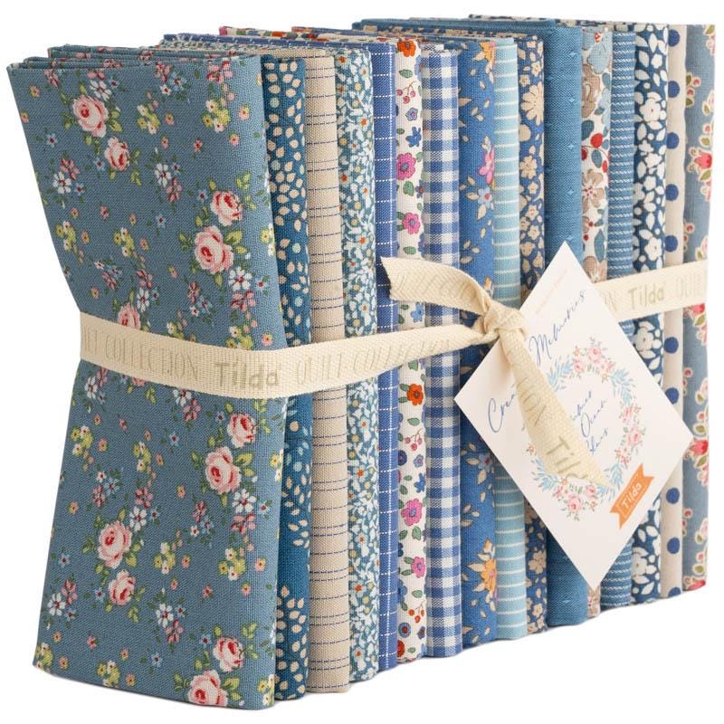 The Tilda "Creating Memories" Summer & Ocean Blues collection is designed by Tone Finnanger, featuring a curated selection of 16 fabrics (a mix of prints and wovens) inspired by the sea and summer days. The collection emphasizes blues, white, and hints of ginger/saffron, characterized by small-scale designs like ditsy flowers, stripes, and dot